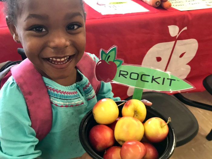 Girl holding Rockit™ apples
